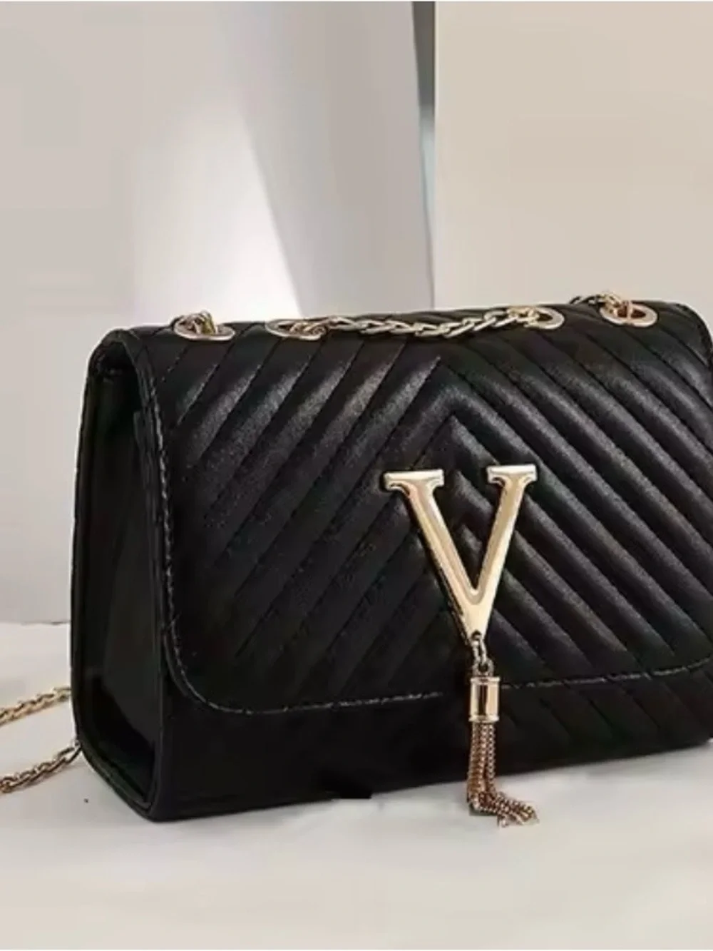 Black Quilted Shoulder Bag with Gold V Tassel